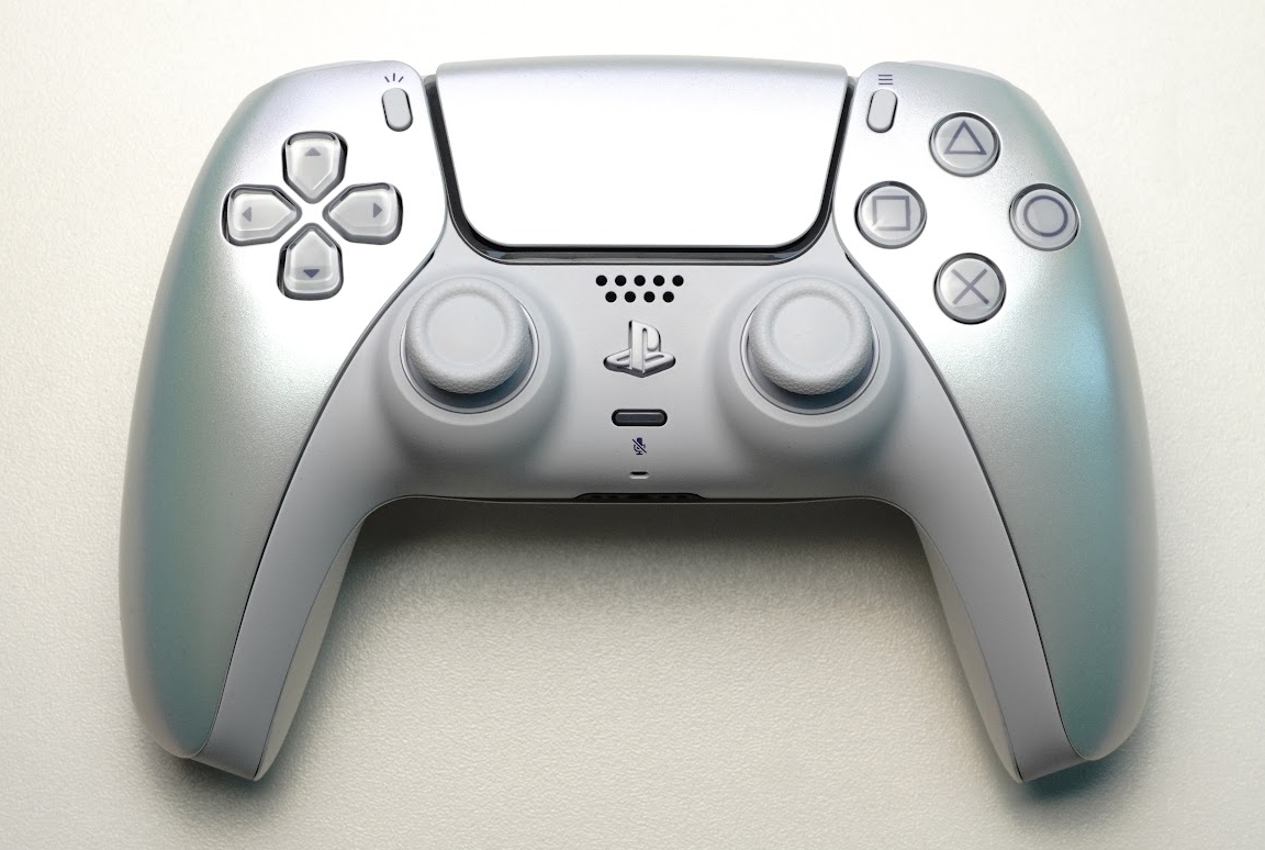A pale iridescent DualSense Chroma Pearl controller resting on a light surface.