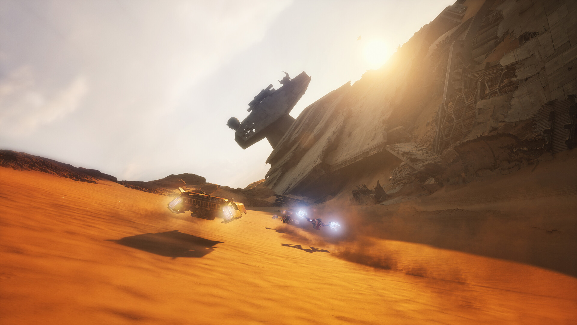 Official Star Wars: Galactic Racer screenshot of speeders racing across desert dunes past a crashed starship