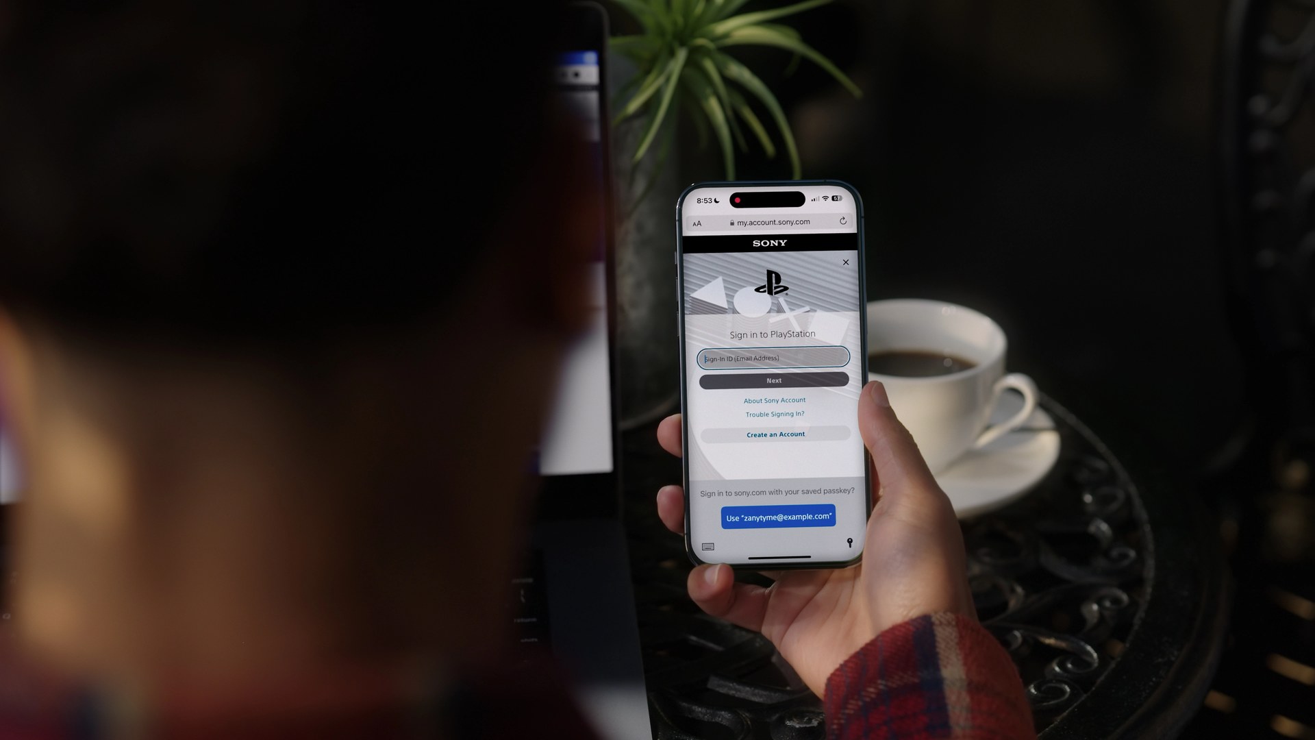 Official PlayStation image of a phone showing the PlayStation sign-in screen with a passkey option